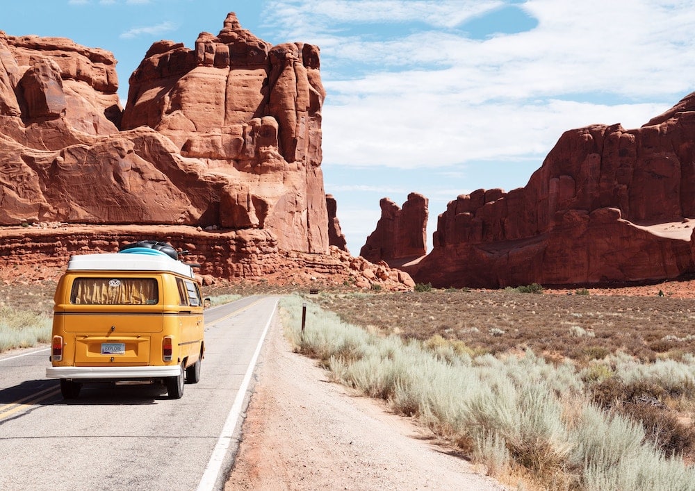 carro na estrada em meio ao deserto para representar se o seguro saúde internacional vale a pena