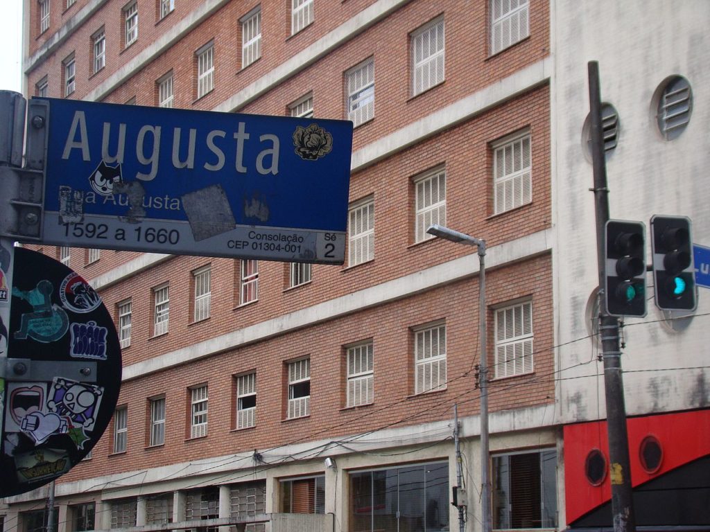 Na foto vemos uma placa de rua indicando a Rua Augusta, um dos pontos turísticos de SP. Foto de Guilherme B Alves via Wikimedia