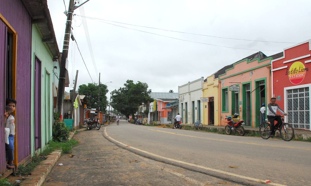 Rua plana e pacata, com casinhas coloridas, em Xapuri, cidade do interior do Acre