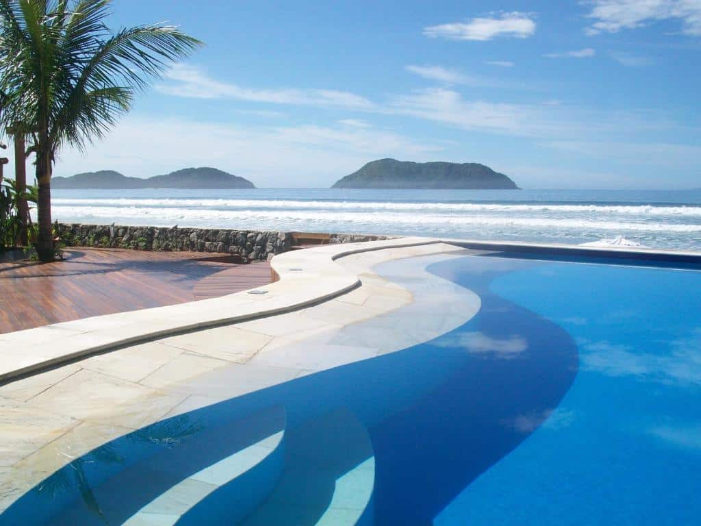 Vista da piscina do Juquehy La Plage Hotel, virado em direção do mar, com a praia logo em seguida da piscina