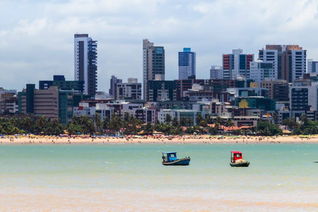 João Pessoa com vista do mar em direção da praia, com os prédios e a cidade logo ao fundo