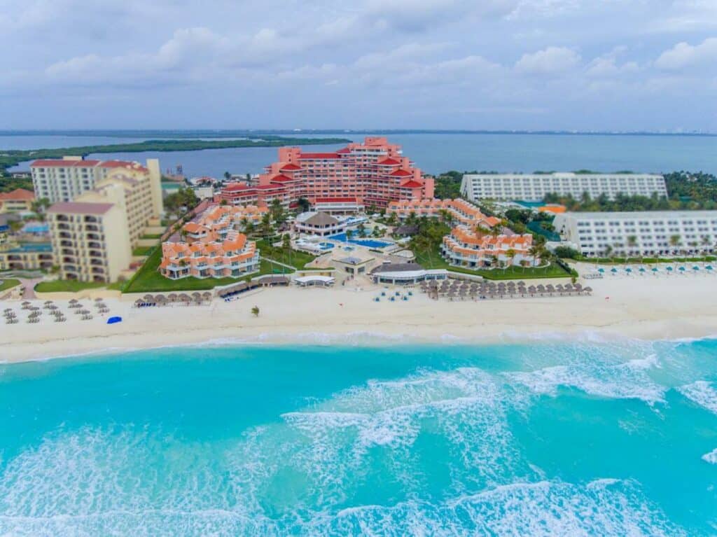 Vista aérea do Omni Cancun Hotel & Villas All Inclusive virado para o mar, de frente para a areia da praia