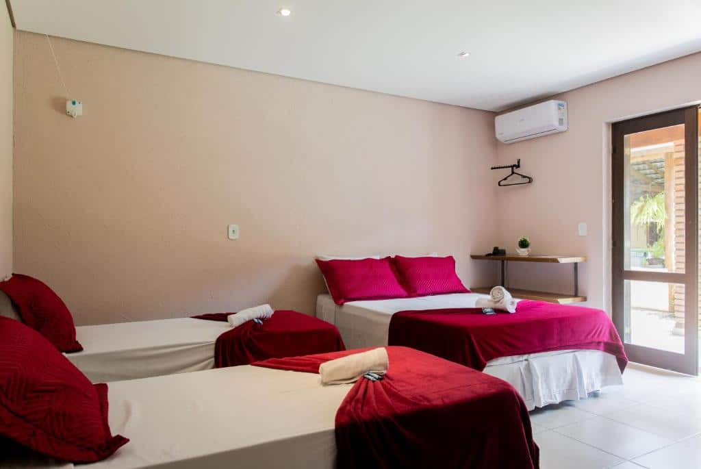 Quarto da Pousada Porto do Rio com uma cama de casal, duas camas de solteiro e ar-condicionado