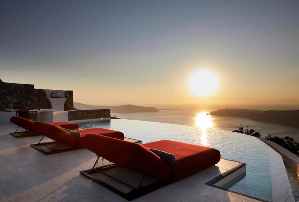 Poltronas e piscina com vista do pôr do sol do White Pearl Cavalieri, um dos hotéis em Santorini