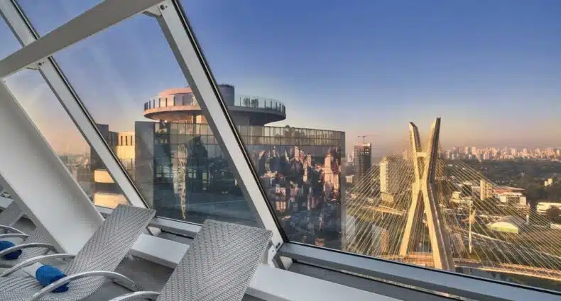 Uma área toda envidraçada da cobertura do Hilton São Paulo Morumbi com vista para a ponte estaiada