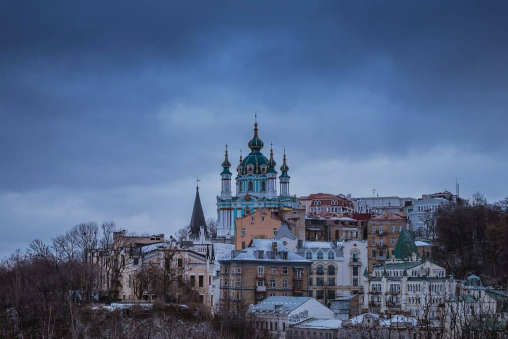 vista da cidade de Kiev, capital da Ucrânia, com construções históricas  ao estilo soviético com algumas cores e uma espécie de igreja bem decorada em tons de azul