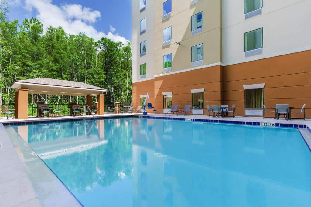 piscina retangular ao ar livre com a fachada atrás do Candlewood Suites - Orlando - Lake Buena Vista, um dos hotéis perto de Lake Buena Vista em Orlando