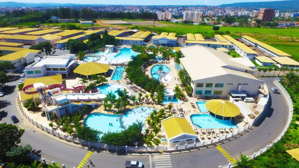 Imagem aérea do resort Lacqua Di Roma Acqua Park com várias piscinas azuis aparecendo, algumas construções com coberturas amarelas, algumas árvores e tudo isso em um espaço com o formato redondo, ilustrando post Hotéis em Caldas Novas.