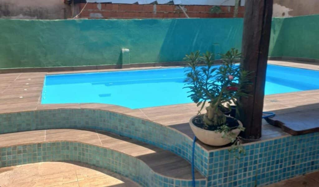 Piscina da Pousada Anayh, Nobres-MT, Vila Bom Jardim. Três degrais na frente com um vaso. No fundo uma piscina.