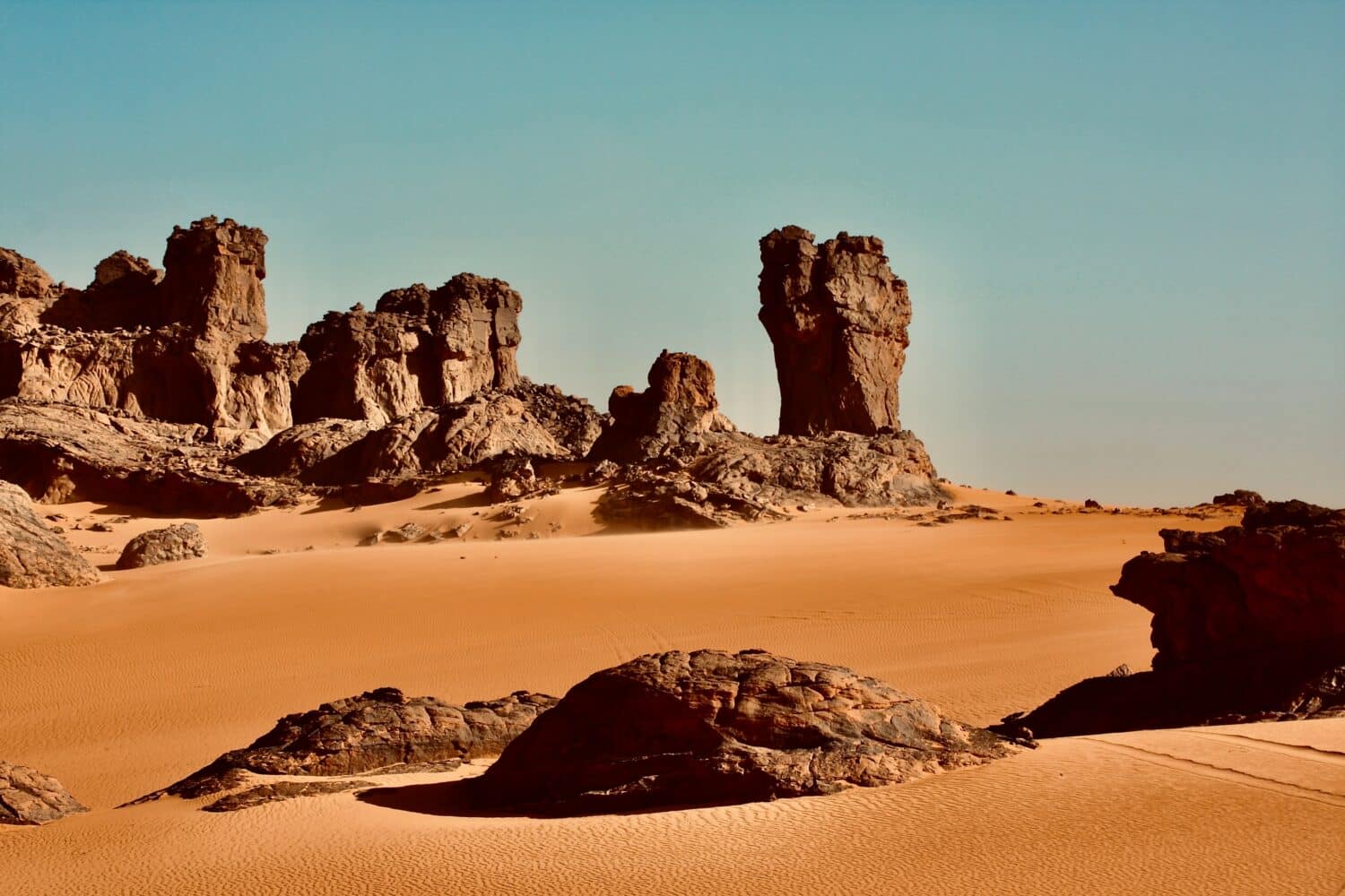 Vista de rochas e areia no Tassili du Hoggar, In Guezzam, Argélia durante o dia. Representa chip celular Argélia.