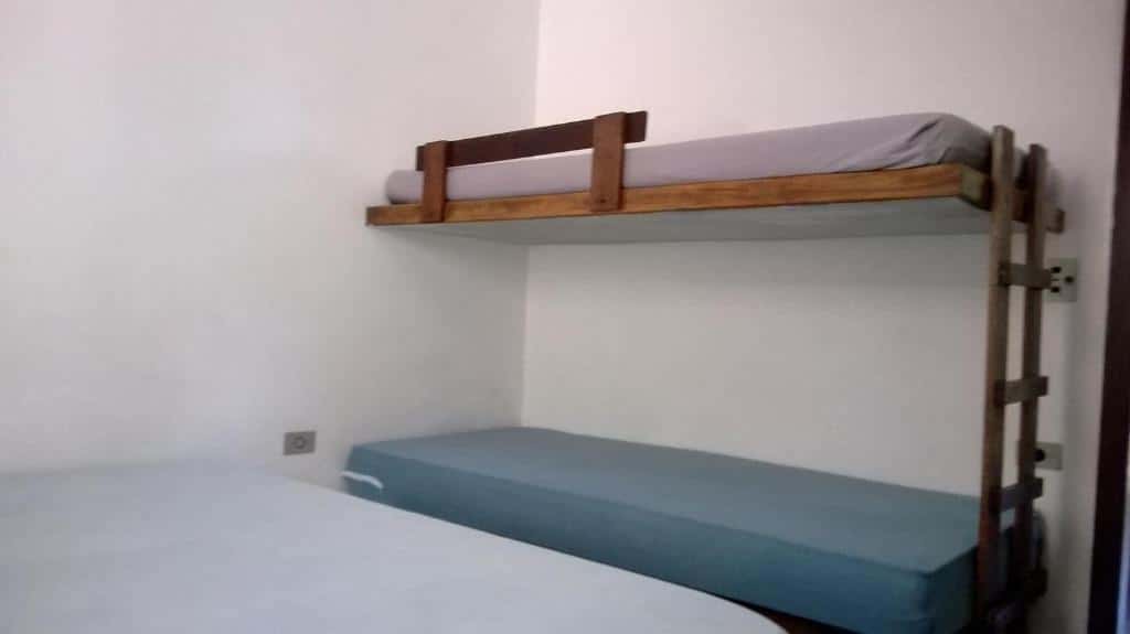Quarto do Cond Apartamentos Chalés San Marino. Do lado esquerdo uma cama de casal, do lado direito uma beliche.