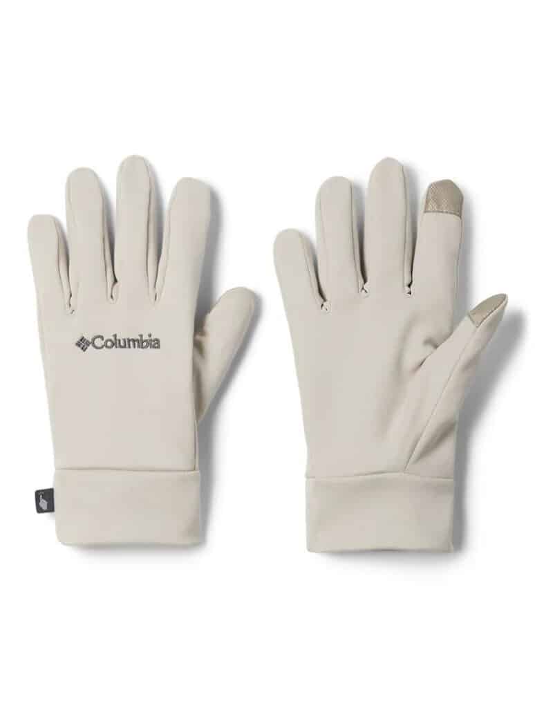 Um par de luvas Columbia bege claro com pontas dos dedos compatíveis com tela sensível ao toque é exibido em um fundo simples.