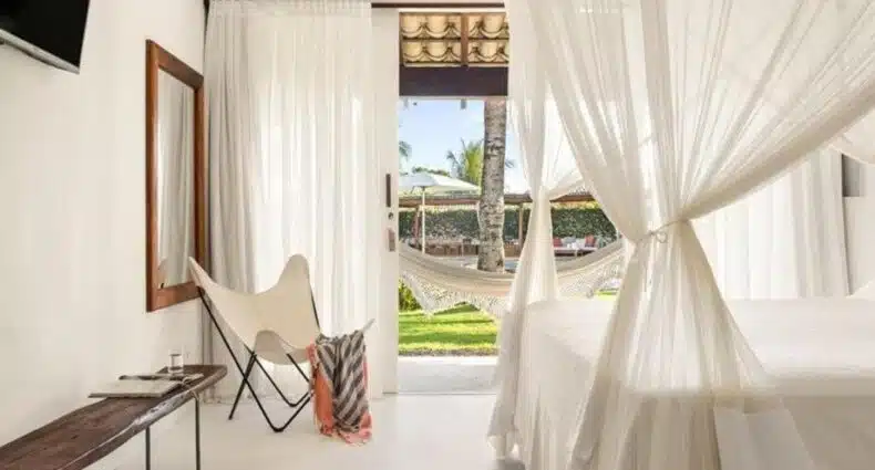 Quarto da Pousada Brisas do Espelho com varandas, rede e vista para jardim tropical. Imagem para ilustrar post sobre onde ficar na Praia do Espelho.